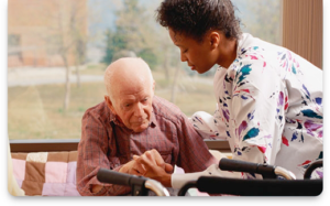 caregiver helping elderly man